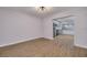 Open-concept living room with wood flooring leading to the kitchen with gray cabinets and stainless steel appliances at 6672 56Th N Ave, St Petersburg, FL 33709