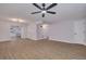 Spacious living room with wood-look flooring, neutral walls, and modern ceiling fan at 6672 56Th N Ave, St Petersburg, FL 33709