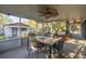Spacious screened-in patio with furniture, a ceiling fan, and view of backyard with lush greenery at 6672 56Th N Ave, St Petersburg, FL 33709