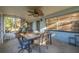 Covered patio with a table and chairs provides an ideal spot for outdoor dining and relaxation at 6672 56Th N Ave, St Petersburg, FL 33709