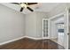 Cozy bedroom with hardwood floors, neutral walls, and a classic ceiling fan at 6816 Guilford Bridge Dr, Apollo Beach, FL 33572