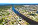 Overhead view captures a waterfront neighborhood with winding canals, private docks, and beautiful homes surrounded by lush trees at 7094 Kenwood Dr, North Port, FL 34287