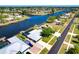 Waterfront homes with backyard docks along a navigable canal and nearby residential streets at 7094 Kenwood Dr, North Port, FL 34287