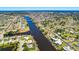 Aerial perspective showcasing waterfront properties with canals, docks, and well-maintained landscaping in a residential community at 7094 Kenwood Dr, North Port, FL 34287