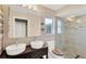 Bright bathroom featuring dual sinks, a glass enclosed shower, and a decorative toilet seat at 7094 Kenwood Dr, North Port, FL 34287