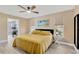 Inviting bedroom with a ceiling fan and windows that provide natural light and a view at 7094 Kenwood Dr, North Port, FL 34287