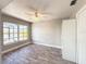 Bright bedroom with tile floors, a ceiling fan, and a sunlit window overlooking outdoors at 7094 Kenwood Dr, North Port, FL 34287