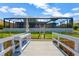 Scenic view of a private dock leading to waterfront, surrounded by green landscape at 7094 Kenwood Dr, North Port, FL 34287