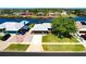 Well-maintained home with a lush lawn, complemented by a paved driveway and vibrant landscaping at 7094 Kenwood Dr, North Port, FL 34287