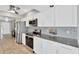 Modern kitchen with stainless steel appliances, gray backsplash, and granite countertops at 7094 Kenwood Dr, North Port, FL 34287