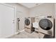 Convenient laundry room with modern washer, dryer, utility sink, and backyard access at 7094 Kenwood Dr, North Port, FL 34287