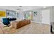 Bright living room with modern furniture, wood flooring, and a large window at 7094 Kenwood Dr, North Port, FL 34287