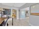 Office leading to bedroom and lanai with desk, chalkboard, and wood-look tile flooring at 7094 Kenwood Dr, North Port, FL 34287