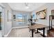 Comfortable office space with ceiling fan, waterfront view, and wood-look tile flooring at 7094 Kenwood Dr, North Port, FL 34287