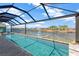 Gorgeous waterfront backyard pool featuring a screen enclosure and direct water access to a beautiful canal at 7094 Kenwood Dr, North Port, FL 34287