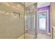 Beautifully tiled shower with a built-in shelf and glass door in a modern bathroom at 7094 Kenwood Dr, North Port, FL 34287