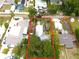 An aerial view of the property shows its location among neighboring homes and surrounding greenery at 714 Gray S St, Gulfport, FL 33707