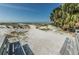 Sandy beach path leads to pristine shores, framed by dunes and native vegetation under a sunny sky at 805 Bruce Ave, Clearwater Beach, FL 33767