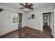 Bedroom featuring hardwood floors, natural lighting, and decorative ceiling fan at 805 Bruce Ave, Clearwater Beach, FL 33767