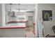 Kitchen featuring white cabinetry, a red counter, and modern pendant lighting at 805 Bruce Ave, Clearwater Beach, FL 33767