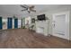 Spacious living room with fireplace, ceiling fans, natural light and hardwood floors at 805 Bruce Ave, Clearwater Beach, FL 33767