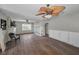 Open living room with hardwood floors, ceiling fans and an archway leading to other spaces at 805 Bruce Ave, Clearwater Beach, FL 33767