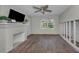 Living room featuring a fireplace, hardwood floors and natural light through the windows at 805 Bruce Ave, Clearwater Beach, FL 33767