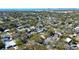 Scenic aerial view of a residential neighborhood with lush greenery and distant bay views at 813 Helena Dr, Largo, FL 33770