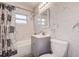 Modern bathroom with gray vanity, patterned shower curtain, and marble-style tile at 813 Helena Dr, Largo, FL 33770