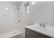 Modern bathroom featuring a tiled shower and grey vanity at 813 Helena Dr, Largo, FL 33770