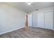 Clean bedroom with gray walls, wood-look floors, and a closet and bathroom access at 813 Helena Dr, Largo, FL 33770