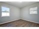 Empty bedroom with wood-look flooring, and natural light from two windows at 813 Helena Dr, Largo, FL 33770