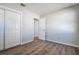 Bedroom with closet, wood-look flooring, bathroom access, and neutral paint at 813 Helena Dr, Largo, FL 33770