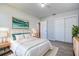 Stylishly furnished bedroom with white bedding, coordinated decor, and wood-look flooring at 813 Helena Dr, Largo, FL 33770