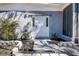 Beautifully landscaped front entrance with stone accents leading to a bright white front door at 813 Helena Dr, Largo, FL 33770