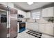 Modern kitchen with white cabinets, stainless steel appliances, and sleek countertops at 813 Helena Dr, Largo, FL 33770