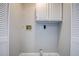 Dedicated laundry space with ample storage cabinets and utility hookups at 813 Helena Dr, Largo, FL 33770