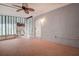 Enclosed patio with durable flooring, a fan, and striped curtains at 813 Helena Dr, Largo, FL 33770