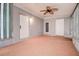 Enclosed patio with durable flooring, fan, and multiple access doors at 813 Helena Dr, Largo, FL 33770
