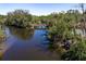 Aerial shot of the river with a wooden bridge, showing the home's unique waterfront location at 8423 Jackson Springs Rd, Tampa, FL 33615