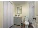 Bathroom featuring a toilet, grey sink and shower at 8423 Jackson Springs Rd, Tampa, FL 33615