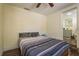 Cozy bedroom featuring a ceiling fan and attached bathroom at 8423 Jackson Springs Rd, Tampa, FL 33615