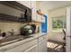 Kitchen with a stainless steel sink, marble countertops and view to the outside at 8423 Jackson Springs Rd, Tampa, FL 33615