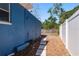 Property side yard with rock path, and a privacy fence for added seclusion at 8423 Jackson Springs Rd, Tampa, FL 33615