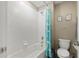 Bathroom showcasing a tub with white subway tile surround and cloud-themed shower curtain at 8609 Winning Fields Rd, New Port Richey, FL 34655