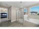 Main bathroom with glass-enclosed shower, soaking tub, and large window at 8609 Winning Fields Rd, New Port Richey, FL 34655
