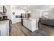Open-concept kitchen featuring an island, stainless steel appliances, and stylish flooring at 8609 Winning Fields Rd, New Port Richey, FL 34655