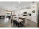Modern kitchen featuring a large island with seating, white cabinets, and stainless steel appliances at 8609 Winning Fields Rd, New Port Richey, FL 34655