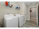 Functional laundry room featuring a modern washer and dryer set, and storage space at 8609 Winning Fields Rd, New Port Richey, FL 34655