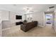 Upstairs living room includes carpet, large TV, and adjacent bedroom at 8609 Winning Fields Rd, New Port Richey, FL 34655